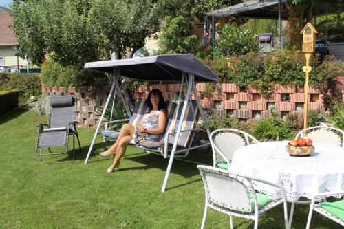 two women sitting in a swing in a yard at Appartements della Schiava in Bad Kleinkirchheim