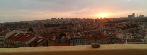 a view of a city with the sun setting at The Sunset Hideout in Lisbon