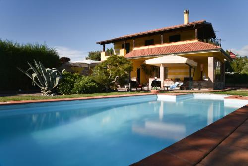 a swimming pool in front of a house at Casa Rosaria in Vezzano Ligure
