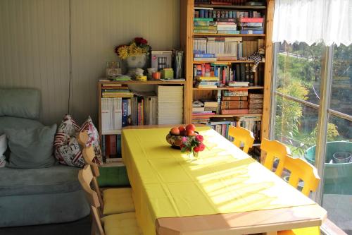 a dining room with a yellow table with fruit on it at Appartements della Schiava in Bad Kleinkirchheim