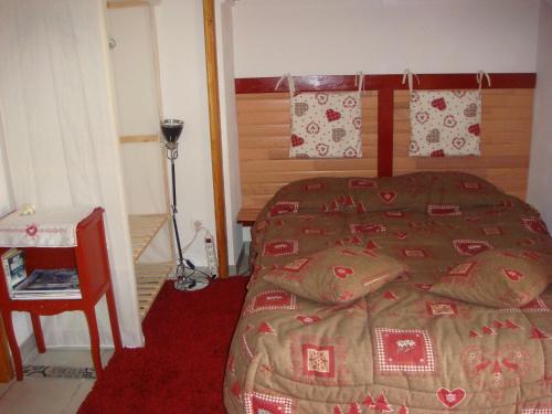 1 dormitorio con 1 cama y alfombra roja en Studio avec solarium en Bourg-Saint-Maurice