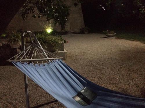 a blue hammock in a yard at night at Tenuta Monaci La Murra in Carmiano