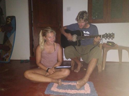 a man playing a guitar next to a woman at Ocean View Beach Resort - Kalpitiya in Kalpitiya
