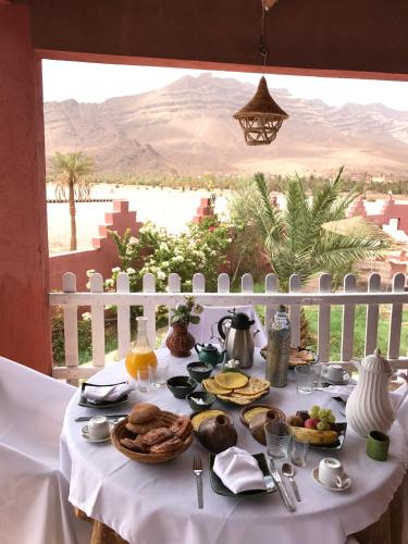 a table with food on it with a view of the desert at Riad Hiba in Foum Zguid