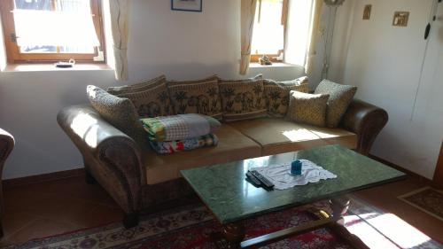a living room with a couch and a table at Chalupa u studny in Lukov