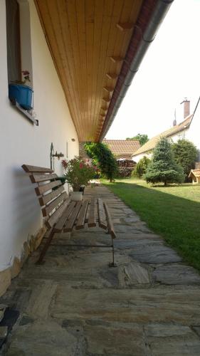 two wooden benches sitting under a roof at Chalupa u studny in Lukov