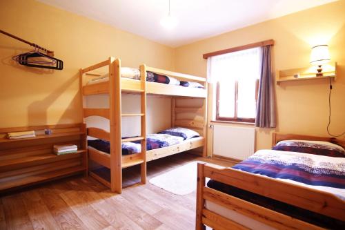 a bedroom with two bunk beds and a window at Ubytovani U Lavky in Suchovršice