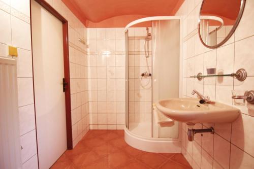 a bathroom with a sink and a shower at Ubytovani U Lavky in Suchovršice