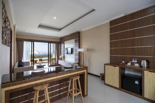 a hotel room with a bar with stools in it at Semabu Hills Hotel Nusa Penida in Nusa Penida