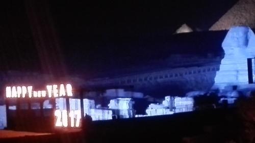 a blurry picture of a building with lights at night at Pyramids Overlook Inn in Cairo