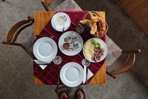 a table with plates of food and bread on it at Holiday homes Piralo in Kostajnica