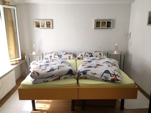 a bed with two pillows on it in a room at Casa Fiorella in Locarno