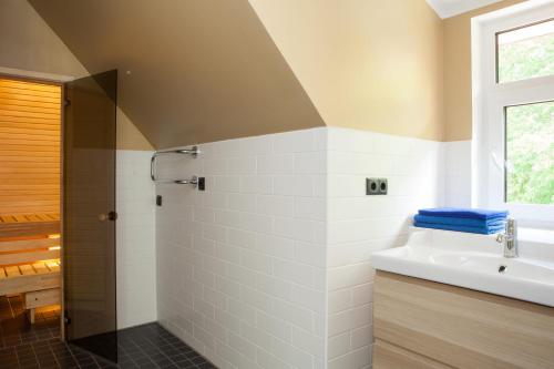 a bathroom with a sink and a shower at Toila Valgevilla Apartments in Toila