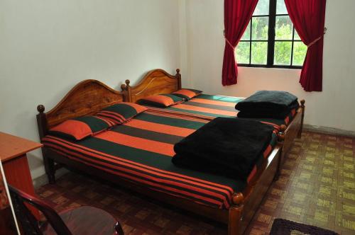 a bedroom with two beds in a room at Akiko Rest in Nuwara Eliya