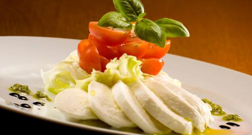 a plate of food with tomatoes and vegetables on it at Penzion Rozmarýn in Vsetín