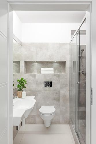 a bathroom with a toilet and a sink and a shower at Sport Rooms II Chodakowska Warszawa in Warsaw