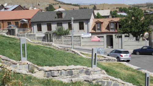 a street with cars parked on the side of a road at Light House Old City in Akhaltsikhe