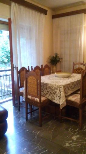 a dining room with a table and chairs and a window at Casa Della Nonna in Radicofani