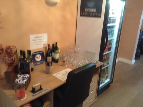 a table with wine bottles and glasses on it at B&B Dorwyn Manor in Avebury