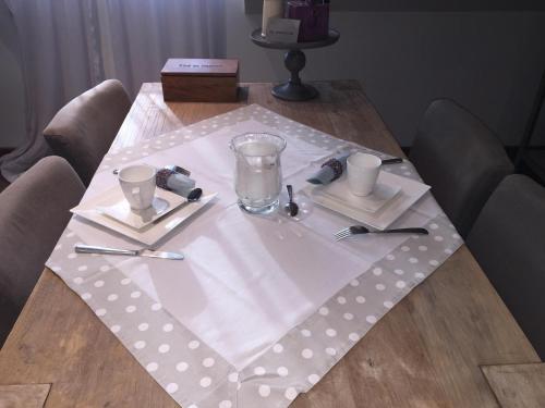 a table with a napkin and utensils on it at B&B Des Heures Claires in Lasne