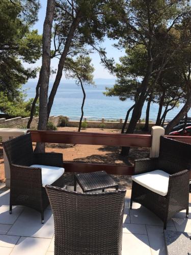a patio with chairs and a view of the ocean at Vila Vera Seafront Apartments in Sumartin