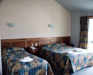 a hotel room with two beds and a window at South Sea Hotel - Stewart Island in Half-moon Bay