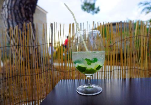 a glass of wine sitting on top of a table at Hostel Casa do Pinheiro in Lagares da Beira