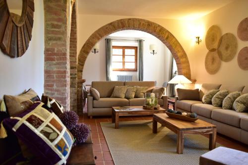 a living room with two couches and a table at Villa San Michele in Barberino di Val dʼElsa