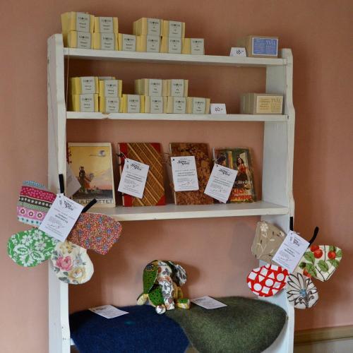 a shelf filled with lots of different types of items at Hotell Dahlströmska gården in Vadstena