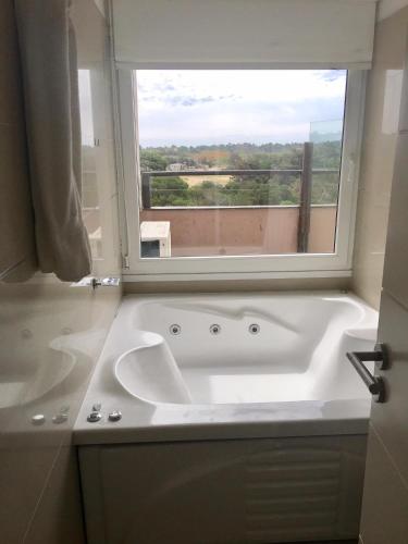 a large bath tub in a bathroom with a window at Linda Bay 205 in Mar de las Pampas