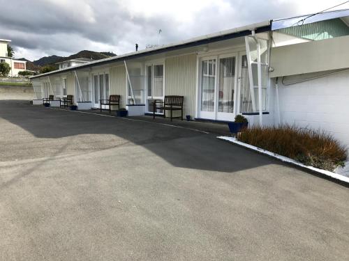 a row of benches on the side of a building at Picton House B&B and Motel in Picton