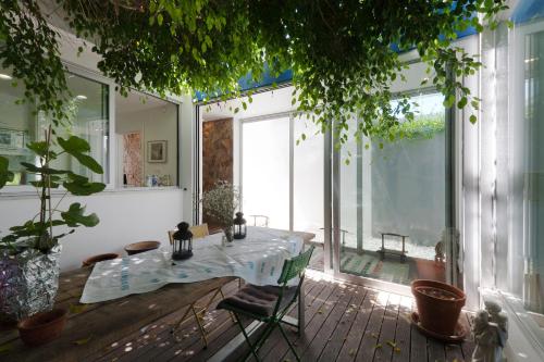 a dining room with a table and a large window at Casa do Pai Beach House in Aldeia do Meco