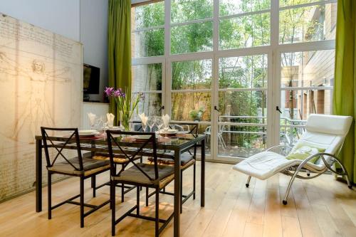 a dining room with a glass table and chairs at B X L R O O M Guesthouse in Brussels