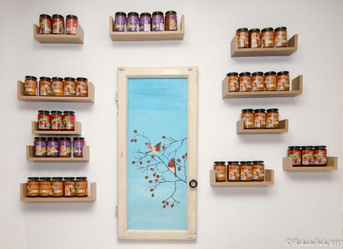 a wall with shelves and a door with canned goods at Agriturismo Monaci Templari in Seborga