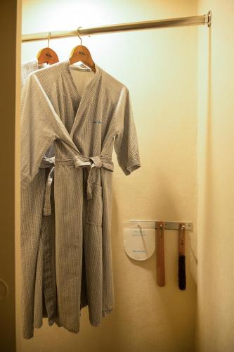 a robe hanging on a rack in a room at Seogwipo KAL Hotel in Seogwipo