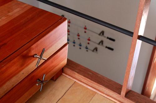 a wooden drawer with the alphabet on it next to a door at Quinua Boutique Apartments in Cusco
