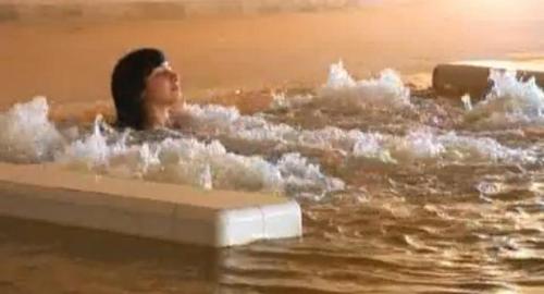 a woman is in a bath tub in the water at Zephir Hôtel & Spa in Zarzis