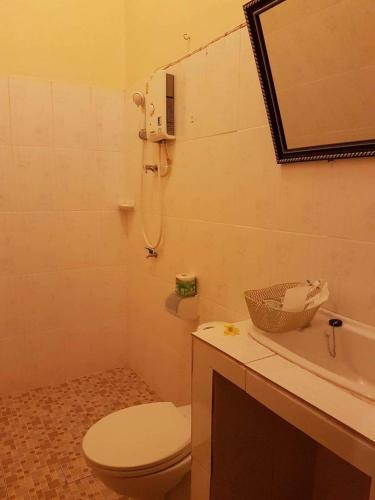 a bathroom with a toilet and a sink and a shower at Xuanmai Garden Resort in Pakse