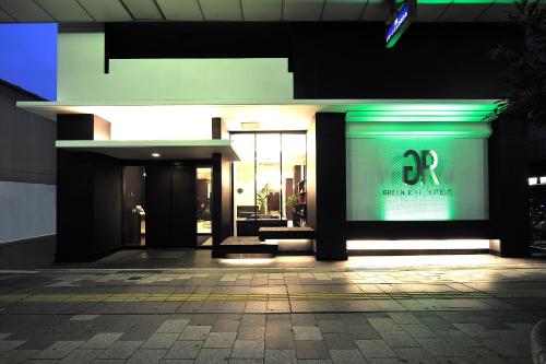 a facade of a building with green lights on it at Green Rich Hotel Iwakuni Ekimae (Artificial hot spring Futamata Yunohana) in Iwakuni
