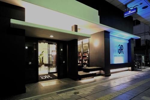 a store with a sign on the side of a building at Green Rich Hotel Iwakuni Ekimae (Artificial hot spring Futamata Yunohana) in Iwakuni