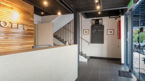 a lobby of a restaurant with a counter and a staircase at MAX Hotel Subang Jaya in Subang Jaya