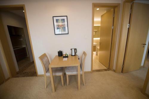 a table and chairs in a room with a hallway at Suzhou Sun Plaza Hotel in Suzhou