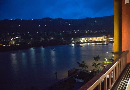 a view of a large body of water at night at Lavasa Luxury Lakeview Studio in Lavasa