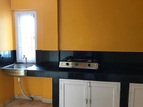 a kitchen with a sink and a counter top at Urbban Castle in Port Blair