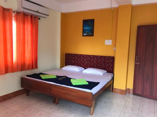 a bedroom with a bed with two towels on it at Urbban Castle in Port Blair