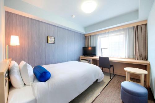 Ένα ή περισσότερα κρεβάτια σε δωμάτιο στο Richmond Hotel Naha Kumoji