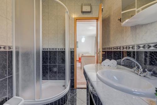 a bathroom with a sink and a shower and a tub at Holiday Home Mirna Vala in Sevid