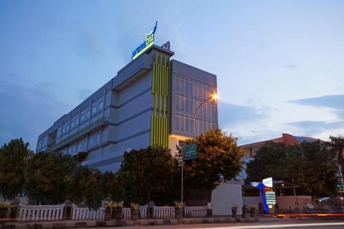a building with a street sign on top of it at PrimeBiz Tegal in Tegal