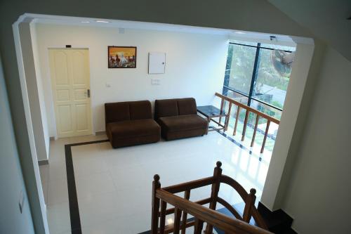 a living room with a couch and a window at Anna Residency in Nedumbassery