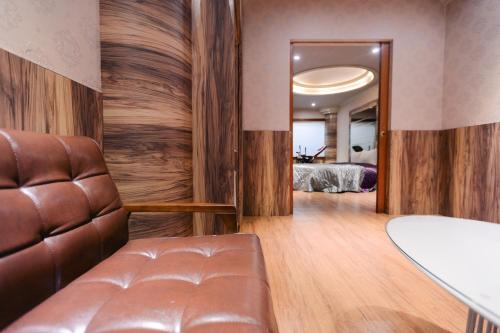 a living room with a couch and a bedroom at Guest Motel- Zhongli Branch in Pingzhen